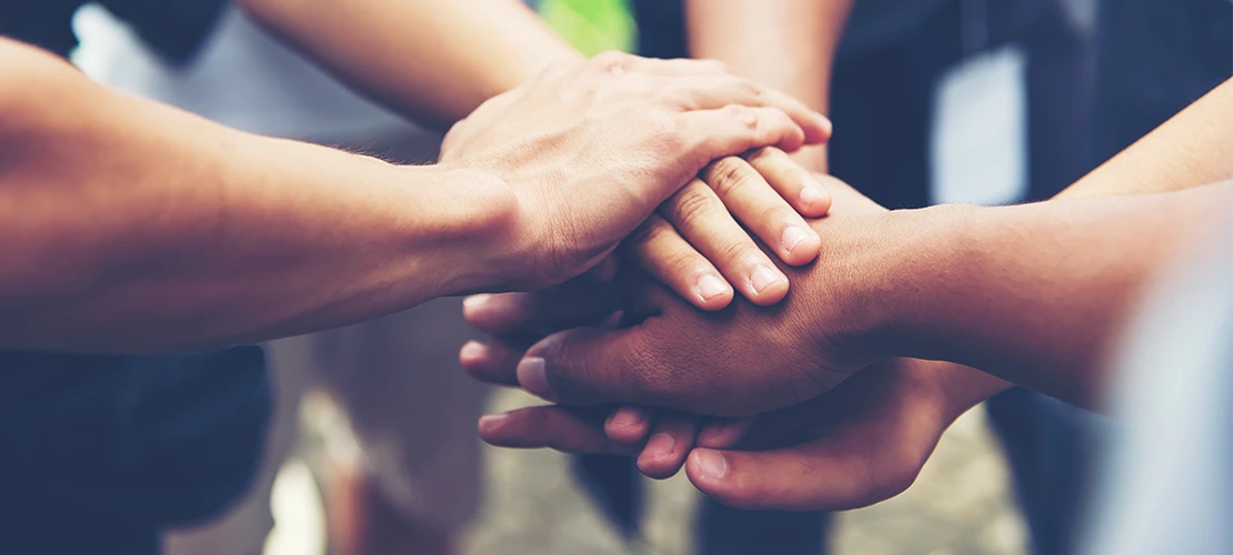 Solidarity unite people hands together community teamwork. Hands of spirit team working together outdoor. 