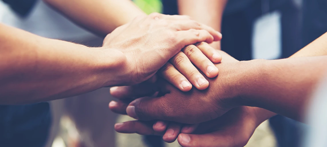 Solidarity unite people hands together community teamwork. Hands of spirit team working together outdoor. 